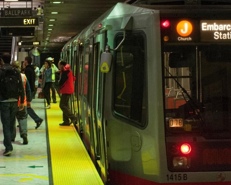 People disembark from a J Church Muni Metro train at Embarcadero Station.