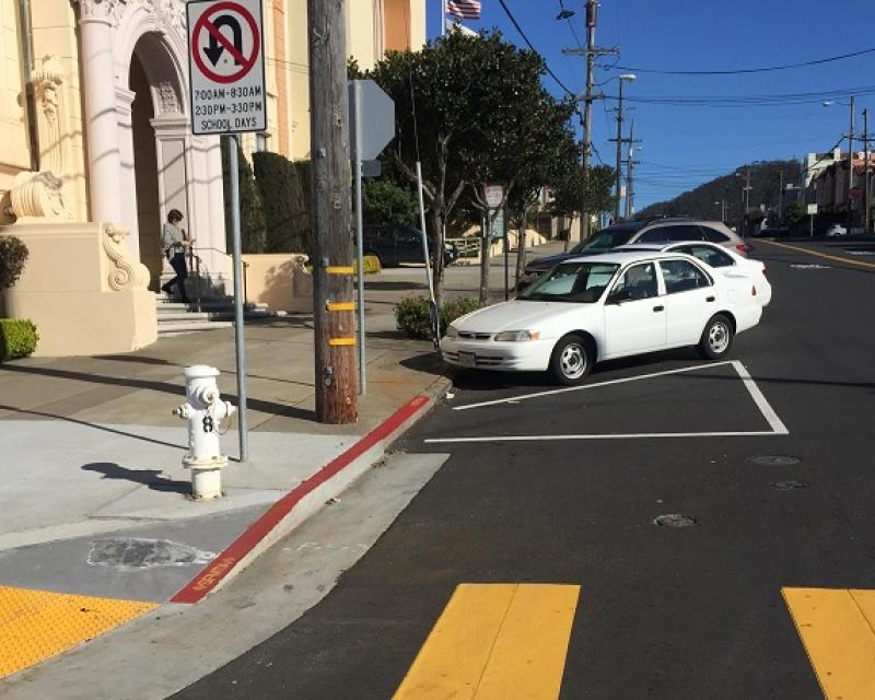 A corner on Vicente Street with existing “front-in” angled parking and “daylighting.”