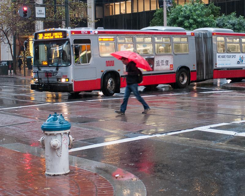 Pedestrian and bus in the rain
