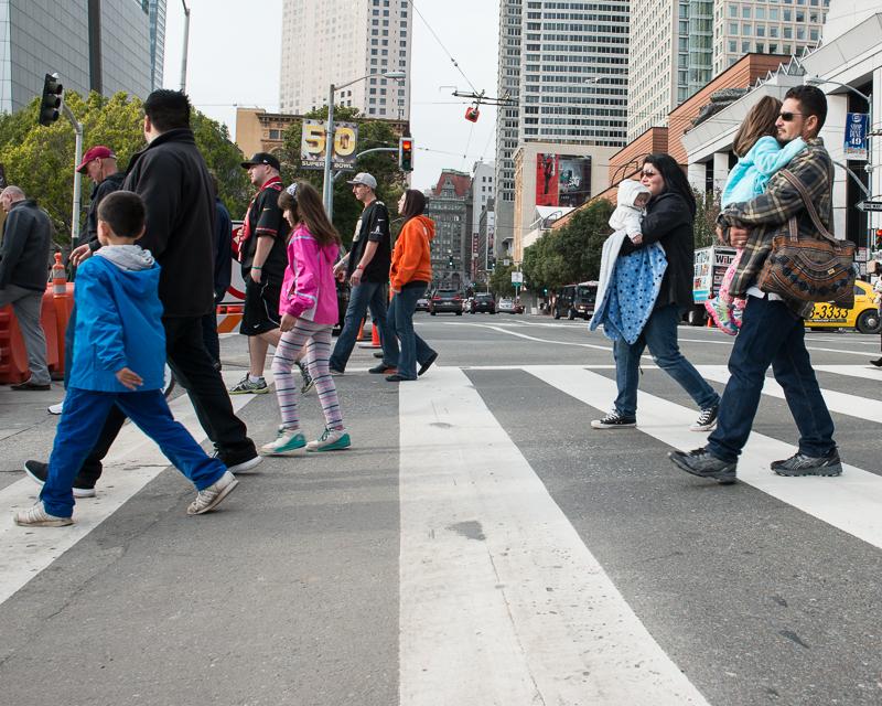 people walking across street in crosswalk