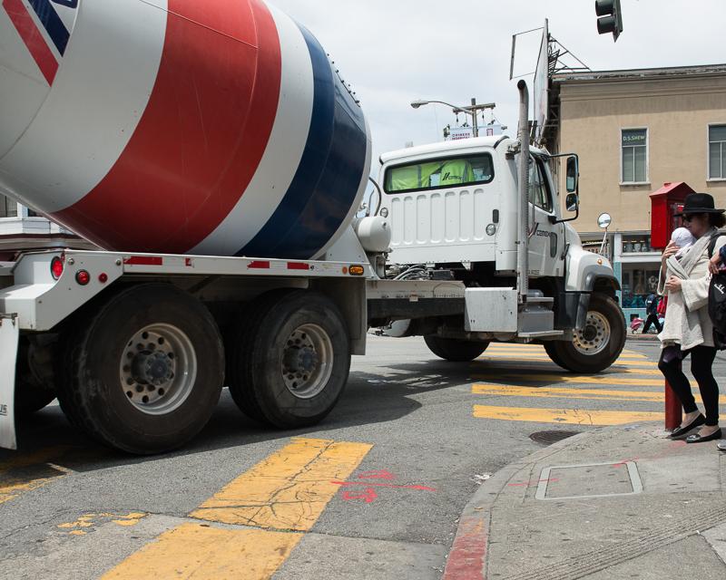 large cement truck turning corner on Broadway