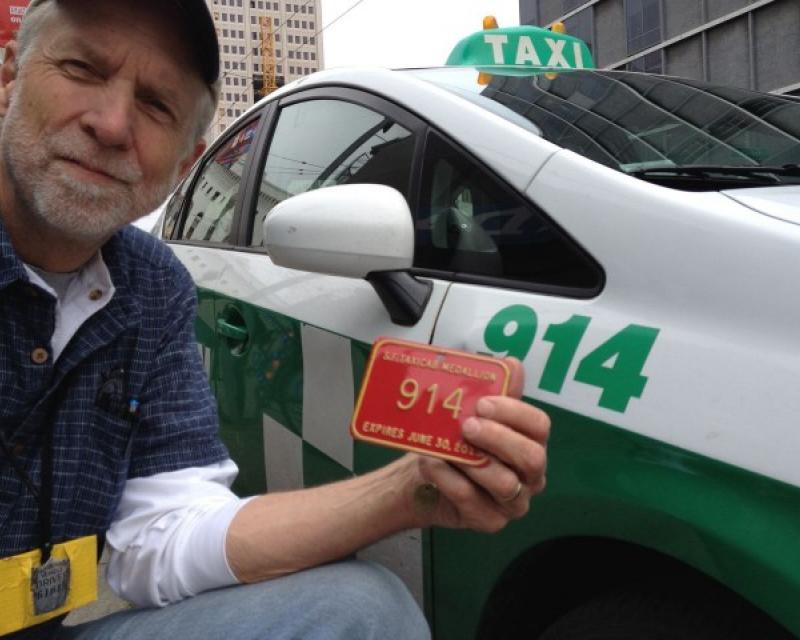 A Taxi driver holding his Medallion