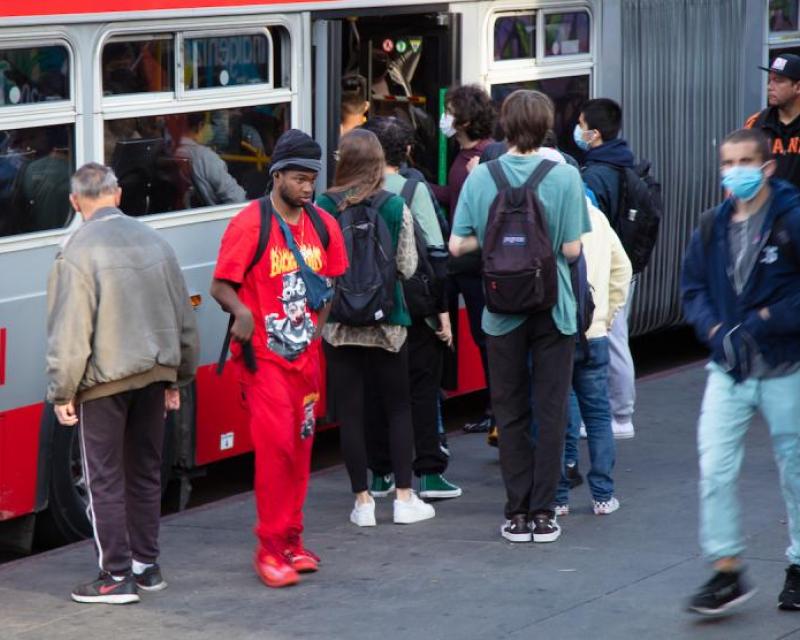 Passengers board very full bus