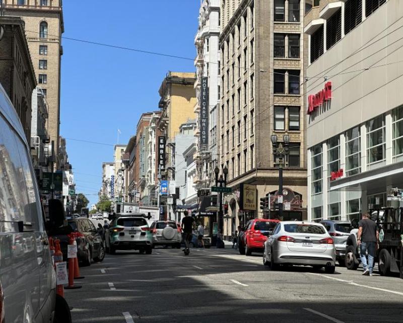 Vehicles and scooter traffic headed west on Sutter at Powell 