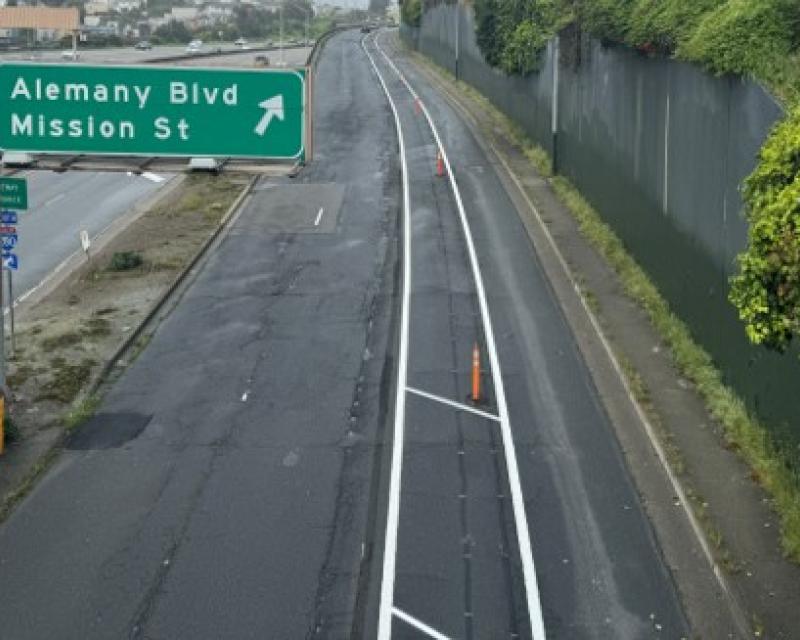 overhead view of Alemany Blvd with two vehicle lanes, buffer, and bikeway.