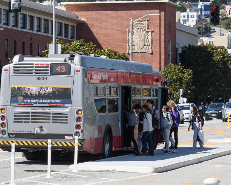 People getting on a bus.