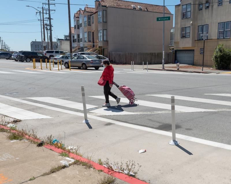 Person crossing the street on Williams Avenue