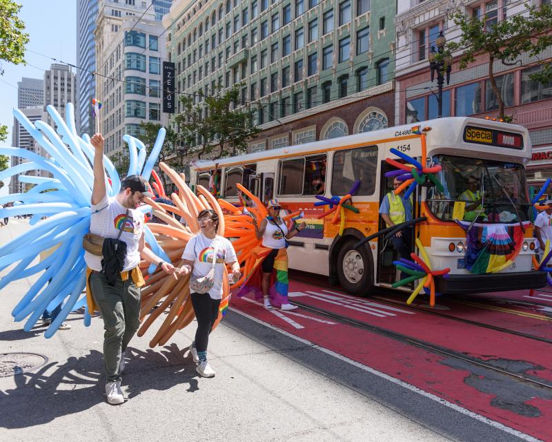 SFMTA contingent at last year's Pride Parade. People hold colorful balloon displays.