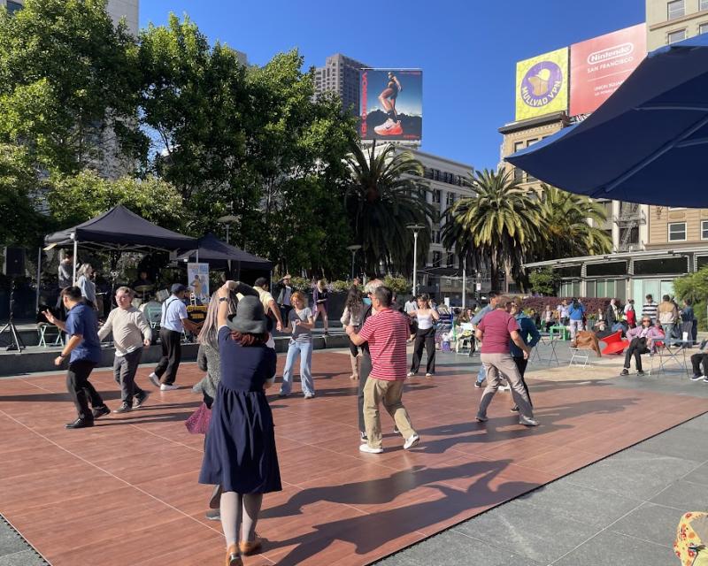 Group of people dancing in Union Square as part of free programming.