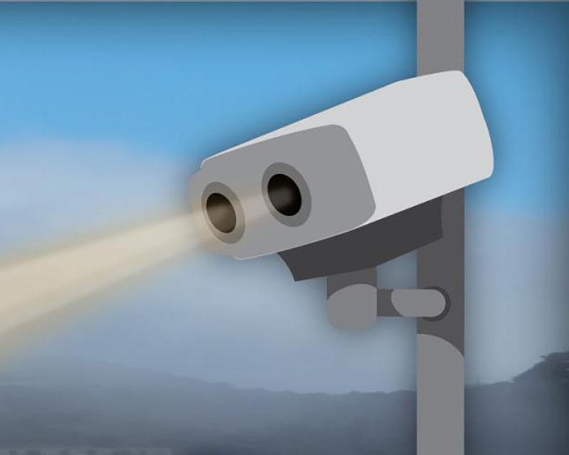 Speed camera mounted on a pole with imagined rays radiating from it