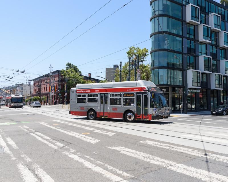37 Corbett bus makes a turn near a building by Church and Market.
