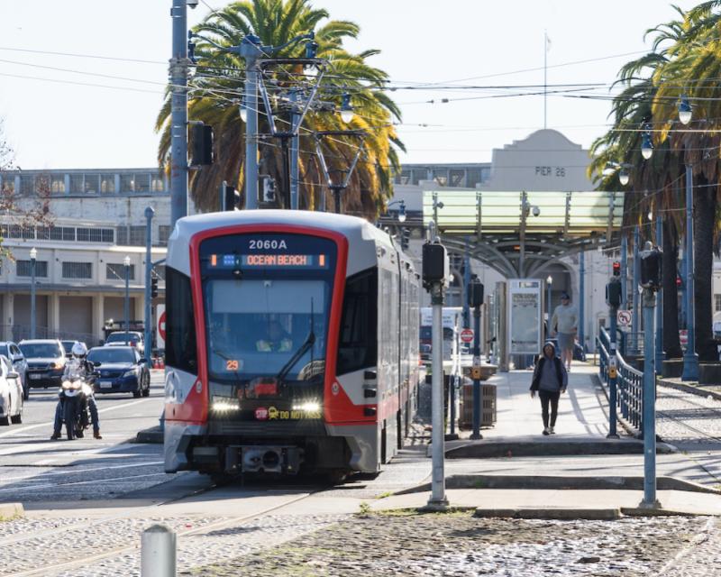 A photo of the N Judah on the Embarcadero with Pier 26 in the background.