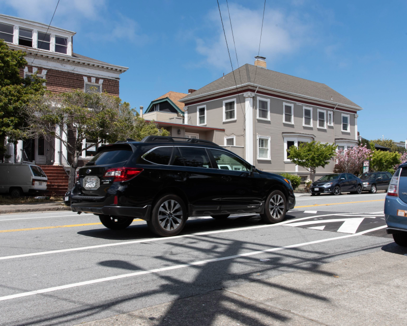 A vehicle drives toward a traffic calming device. 