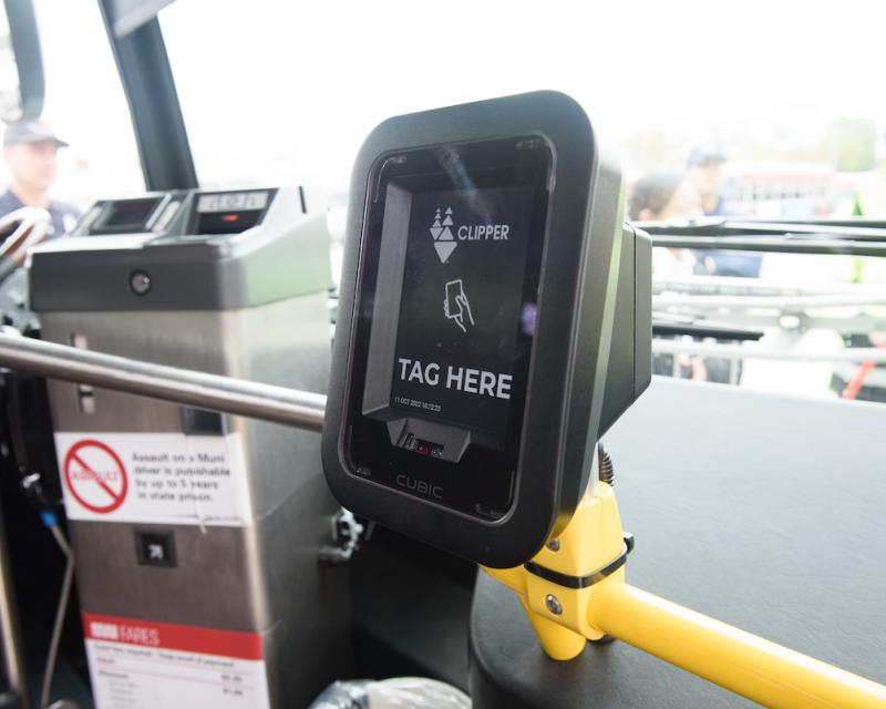 A machine attached to the dashboard of a bus.