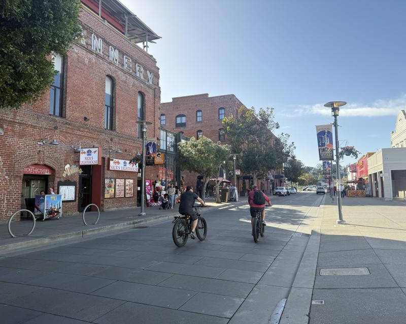 Bicyclists on Jefferson Street, looking west in front of the Cannery