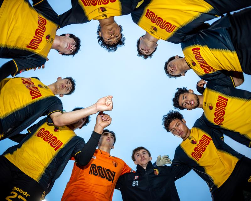 SF City Football Club players in Muni "worm" logo jerseys.