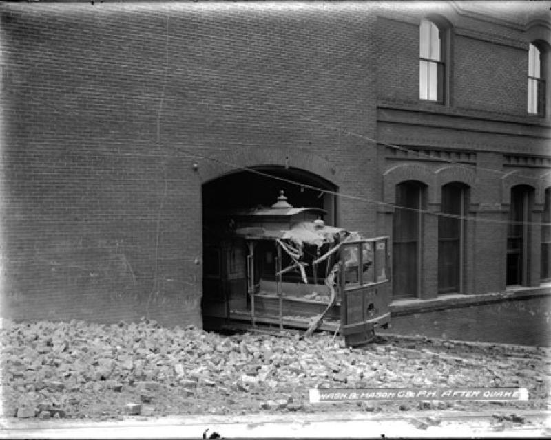 A damaged cable car surrounded by bricks    