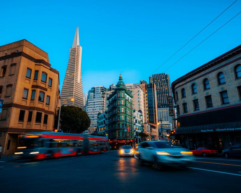 Buildings and a street with cars and a bus on it