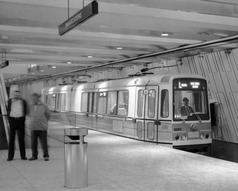 Black and white photo showing a Boeing LRV stopped at an empty platform in Embarcadero Muni Metro Station.