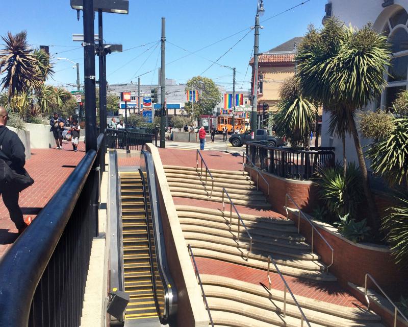 People walking around Harvey Milk Plaza and Castro Station entrance