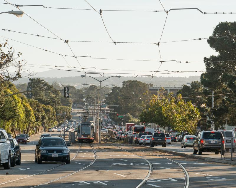 view of traffic and M Line train on 19th Avenue