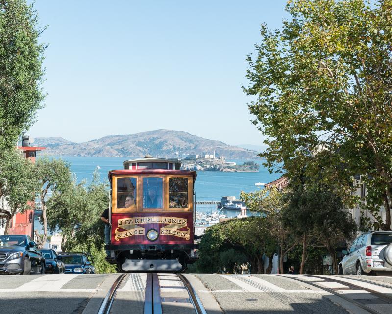 view of cable car and bay from hyde and chestnut streets in russian hill neighborhood