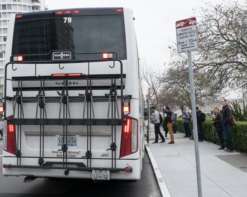 Photo of commuter shuttle picking up passengers.