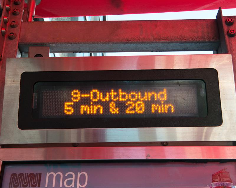 Next Muni Bus prediction sign reads 5 minutes until next 9 San Bruno bus heading outbound arrives