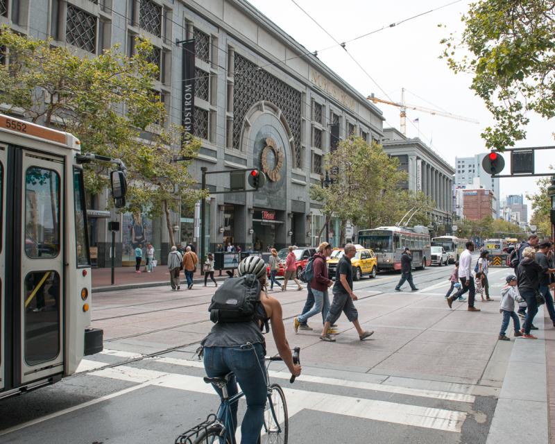 Pedestrians, cyclist, and Muni on Market Street near 5th