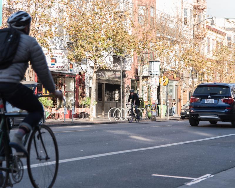 A cyclist and vehicle on Valencia Street