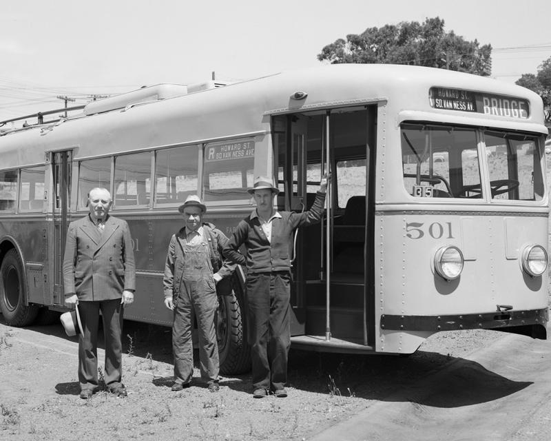 three men with r howard trolley coach