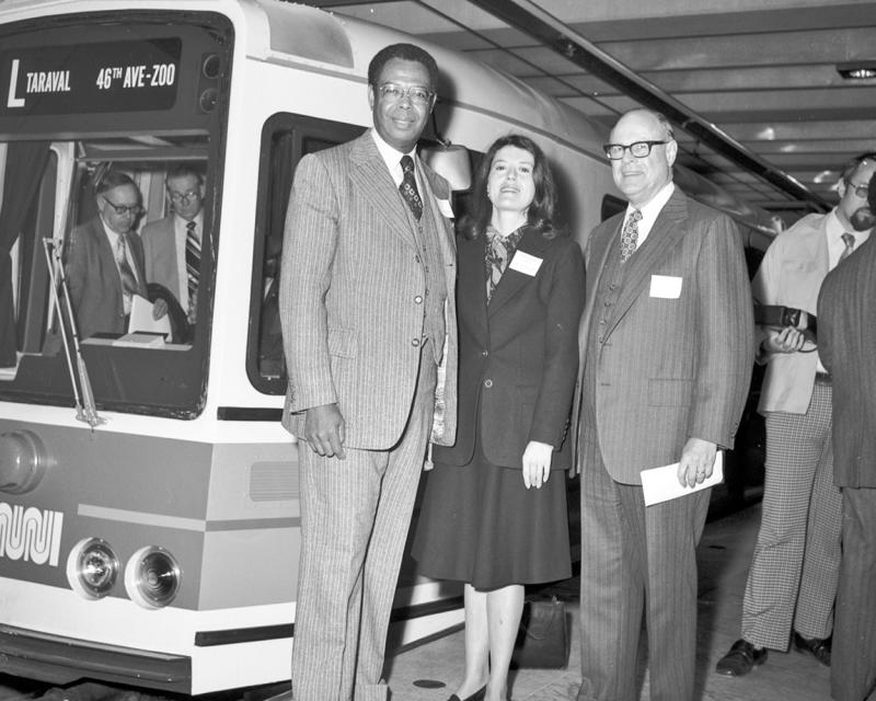 group of city officials with new Muni light rail vehicle in subway station