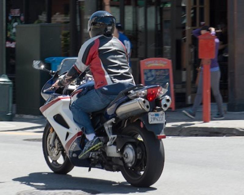 Motorcycle driving through intersection.