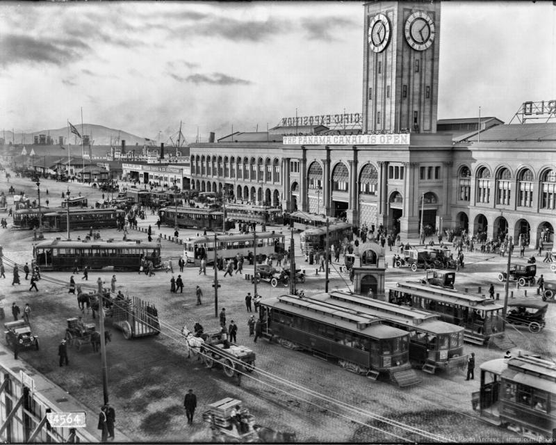 ferry building busy with people, streetcars, and autos