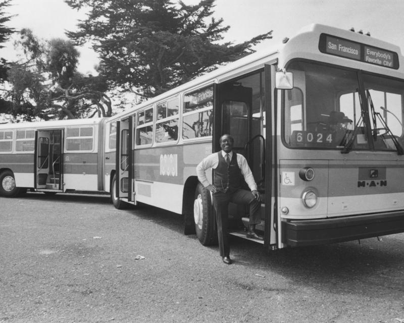 Muni driver posing with articulated bus at end of Geary route.