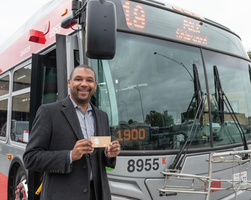 Supervisor Walton with Rosa Parks plaque in front of 19 Line coach