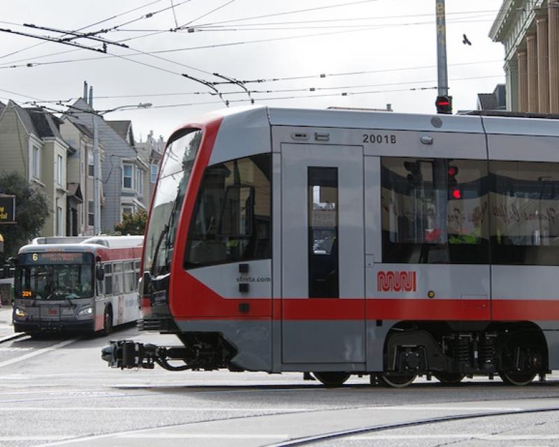 N Judah making the turn and a 6 coach picking people up.