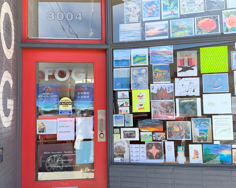 Fog storefront with art in the window