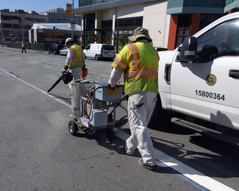 Work crews paint 4th Street Transit Lane