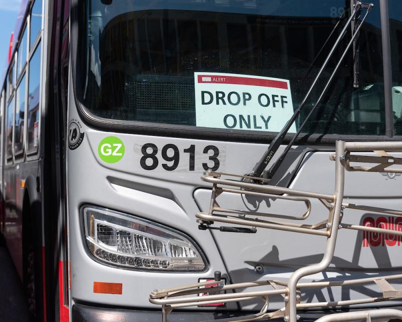 Muni bus with a "Drop Off Only" sign