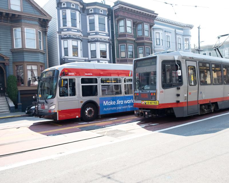 Photo of a Muni bus and Muni Metro side by side