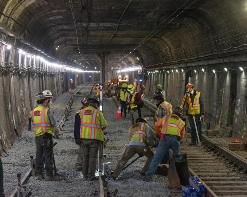 Workers laying track in the Twin Peaks tunnel