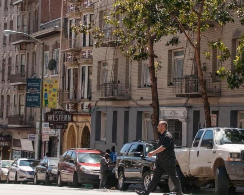 Photo of pedestrian crossing Leavenworth Street in the Tenderloin