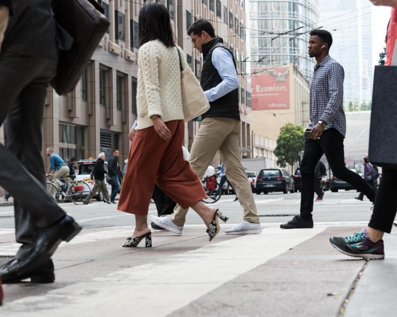 Pedestrians crossing 1st Street at Market Street