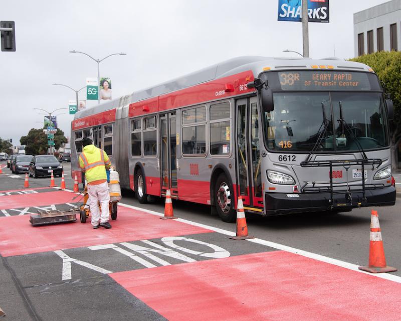 Photo of crew striping red paint on Geary Boulevard