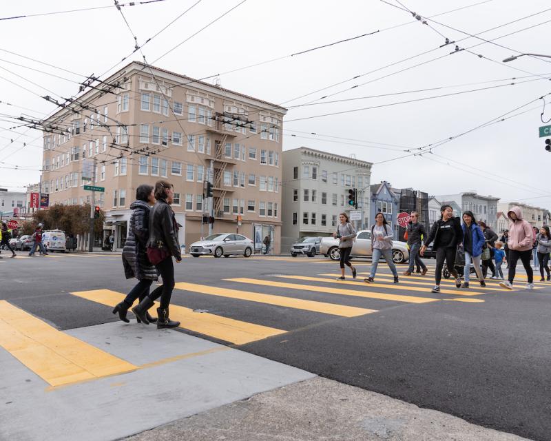 Photo of teenagers crossing a street