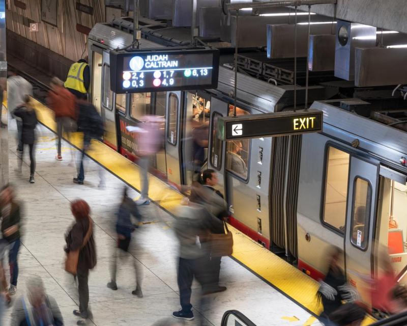 Blurred image of people loading on to train at Embarcadero Station