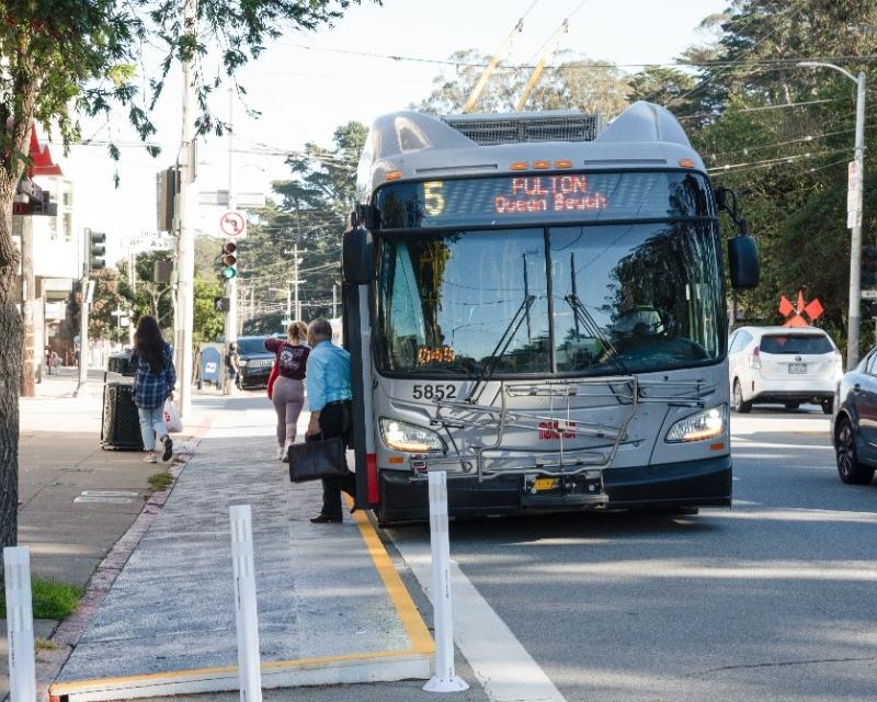 A 5 Fulton bus boards passengers at a temporary bulb