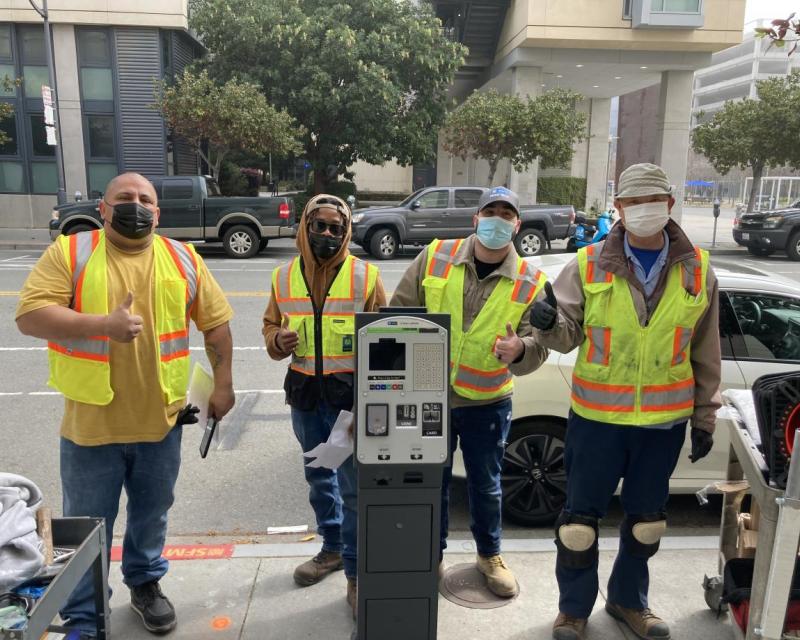 Parking meter shop crew installing the new pay-by-license-plate paystation system on 4th Street at UCSF Mission Bay Campus 