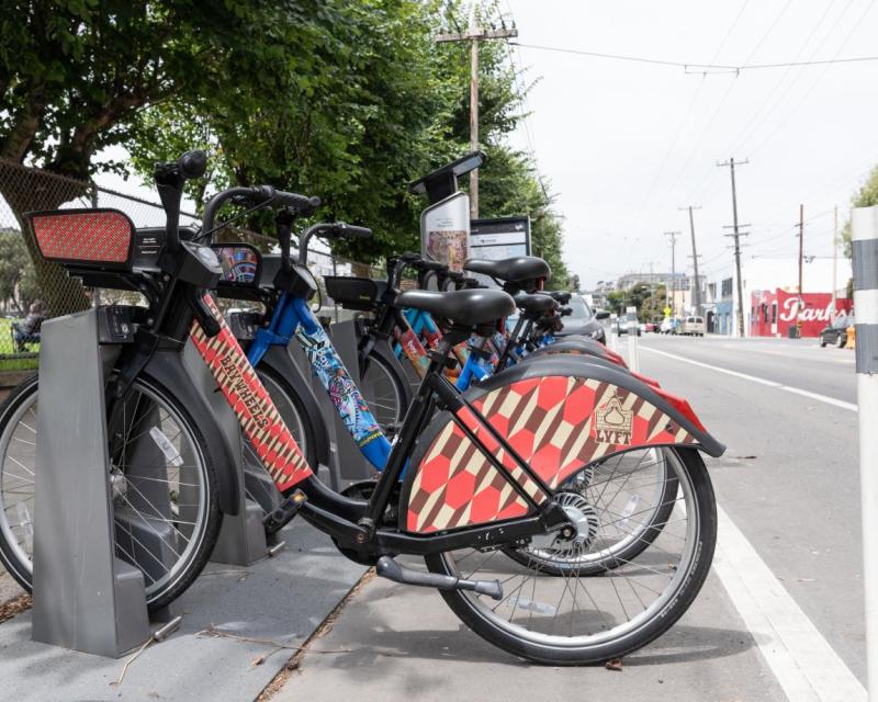 Photo showing e-bikes docked at docking station
